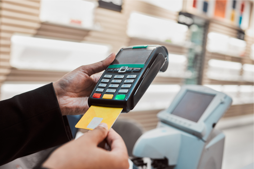 Eye care clinic staff accepting card payment from patient