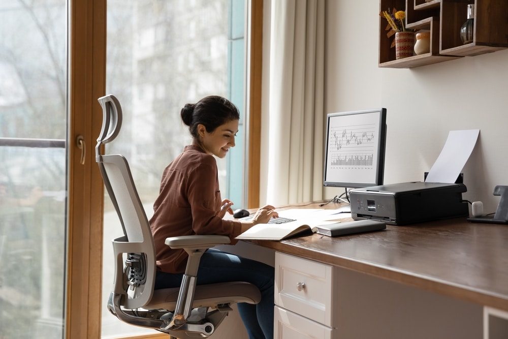 A woman working at a desk and looking at aged accounts receivable information A woman working at a desk and looking at aged accounts receivable information