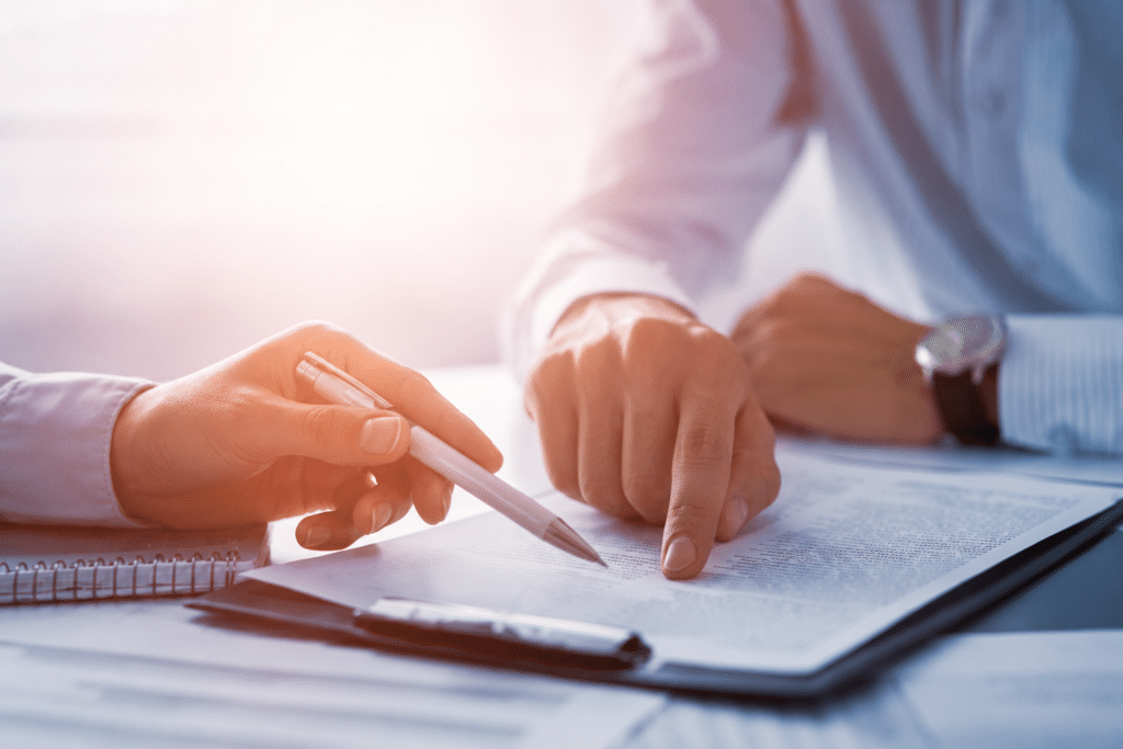 Close-up shot of hands while men discuss accounts receivable for an ophthalmology practice